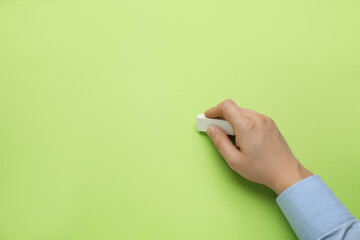 Man erasing something on green background, closeup. Space for text
