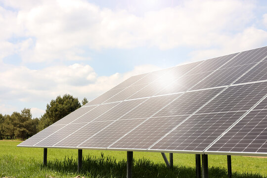 Solar panels in field on sunny day. Alternative energy