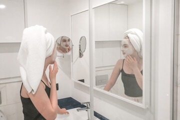 Beauty concept. Wellness, taking care yourself. Portrait beautiful woman looking in the mirror in...