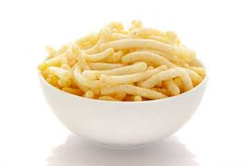 Close up of Cheese Puff Snacks cream color, Popular Ready to eat crunchy and puffed snacks cheesy salty pale-yellow color