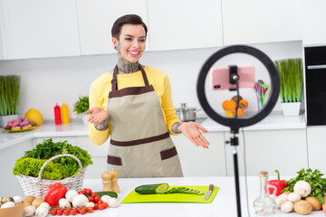 Photo of young cheerful young female with tattoo piercing have online stream cooking channel blogger