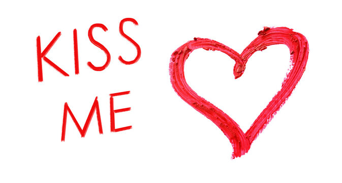 Heart drawn with red lipstick and phrase Kiss Me on white background