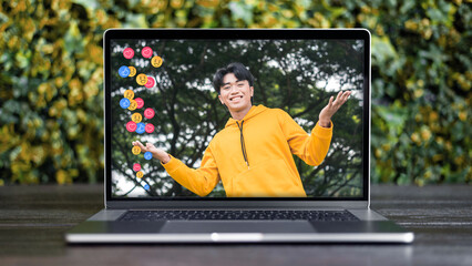 A livestream or vlog of a young male influencer getting increased social media engagement and multiple positive reactions. Laptop mockup scene.