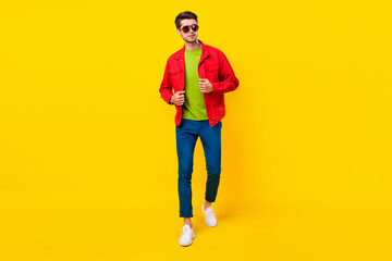 Full size photo of cool brunet young guy go wear shirt pants shoes isolated on yellow background