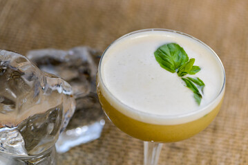alcoholic basil cocktail decorated with a basil leaf macro photo