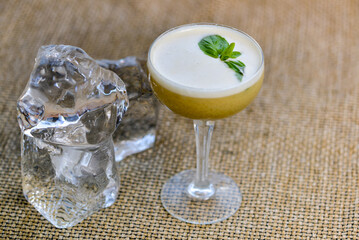 alcoholic basil cocktail decorated with a basil leaf