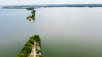 Aerial view boat approaching the original breach of Lake Dallas Dam aka The Cut divides upper, lower halves of Lake Lewisville