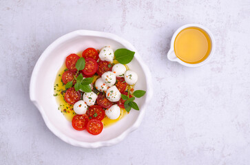 Tomato slices with cheese balls and spicy oil