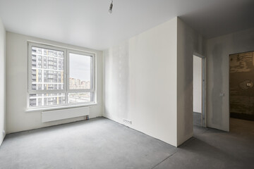 Interior of new apartment without finishing in gray tones