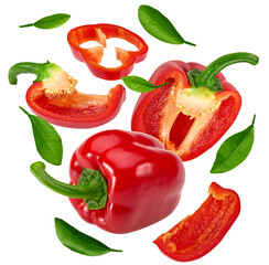 flying sliced red sweet bell pepper with green leaves isolated on white background. clipping path