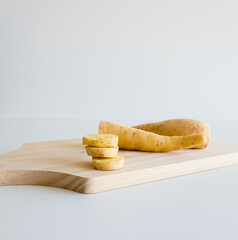 baroa potatoes over wooden table on white background