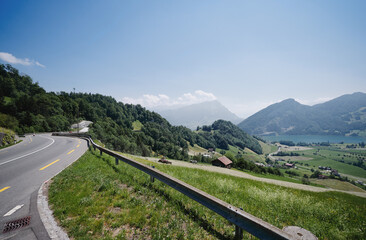 Fototapeta na wymiar Asphalt road in Alp mountains. Road trip concept. Beautiful landscape.