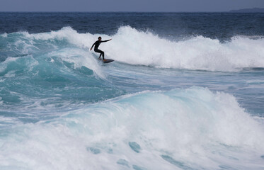 PUERTO DE SANTIAGO, TENERIFE - JUNE 2022: surfer riding the waves in Tenerife