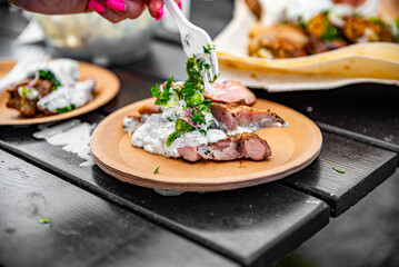 paper plate with meat and sause outdoor