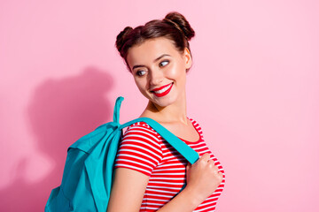 Profile portrait of pretty cheerful girl hold bag look interested empty space isolated on pink color background © deagreez