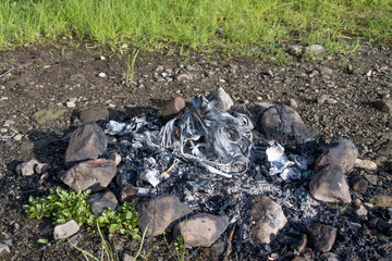 campfire with burnt waste 