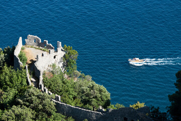 View from above, stunning view of a gozzo boat with tourists on board sailing on a blue water....
