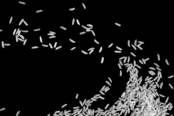 Top view, pile of white uncooked rice grains. Isolated black background.	
