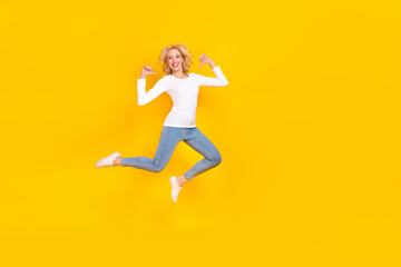 Fototapeta na wymiar Full length photo of cool millennial blond lady jump index myself wear shirt jeans sneakers isolated on yellow background