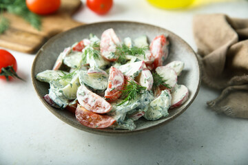 Homemade vegetable salad with tomato, cucumber and sour cream