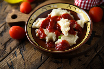Traditional homemade dumplings with tomato sauce