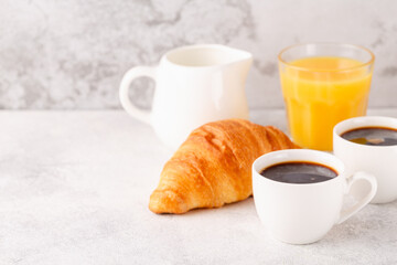 Hot coffee, croissants on a light background, selective focus.