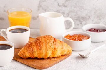 Hot coffee, croissants on a light background, selective focus.