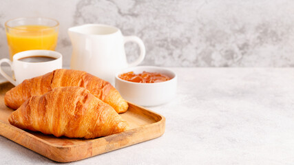 Hot coffee, croissants on a light background, selective focus.