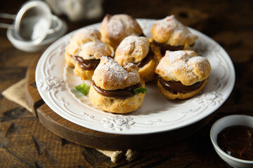 Homemade profiteroles with chocolate paste