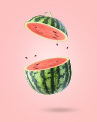 Watermelon flying in the air isolated on pink background.