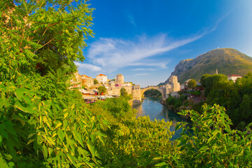 Fantastic Skyline of Mostar with the Mostar Bridge, houses and minarets, during sunny day....