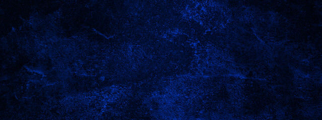 Blue textured paper or concrete wall background. Dark edges. copy space, dark blue rough grainy stone or concrete wall texture background.
