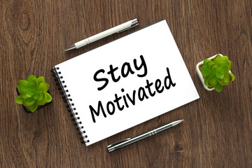 stay motivated text on wooden table background