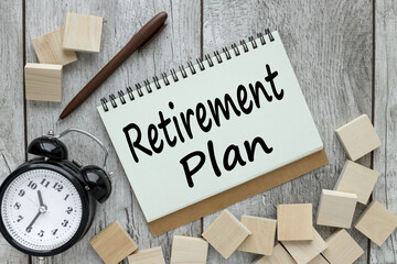 retirement plan text on an open notepad on a wooden background