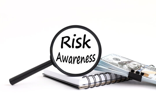 Text Showing Inspiration Risk Awareness. Business Concept Recognizing Factors That May Cause A Life Threatening Effect Typing New Edition Of Informational Ebook. Text On The Magnifying Glass