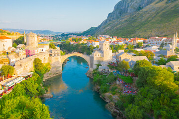 Fantastic Skyline of Mostar with the Mostar Bridge, houses and minarets, during sunny day. Location: Mostar, Old Town, Bosnia and Herzegovina, Europe © SametGuler