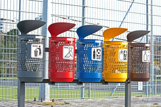 Color coded trash cans for different kinds of waste including recyclables.