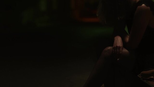 Female prostitute with cigarette on the street.