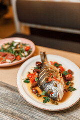 dish plate with whole fried fish in a restaurant.