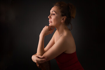 Naklejka premium portrait of a sensual fifty year old woman on grey studio background