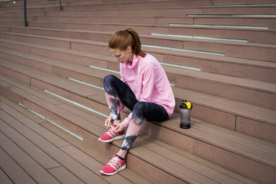 Sports woman tying her shoelaces