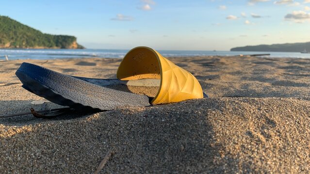 One-sided Sandals With Yellow Color On The Beach Sand