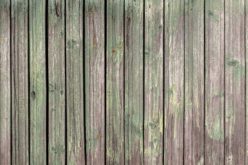 Light background of vertical boards in peeling green paint