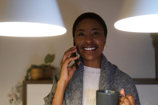 African American woman talking on mobile phone and Smiling