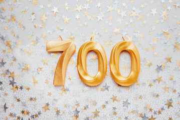 700 seven hundred followers card golden birthday candle on Festive Background. Template for social...