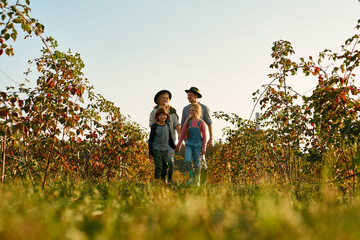 Bottom view of family walk in countryside garden