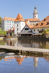 Fototapeta na wymiar Tower and old buildings in Český Krumlov historic district seen from Vltava river waterfront