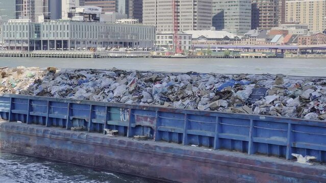 Trash barge transporting solid waste on East river in New York, USA