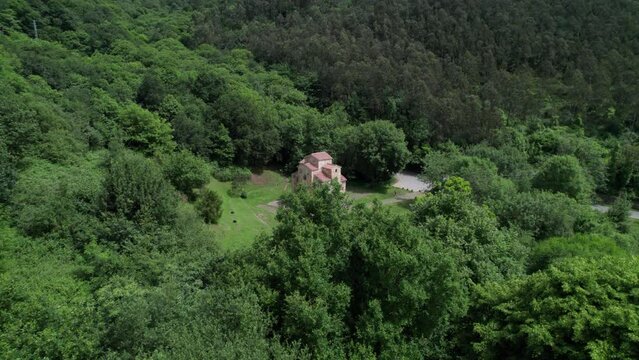 San Miguel De Lillo pre romanesque historical church in middle of forest in Asturias, Spain. Aerial
