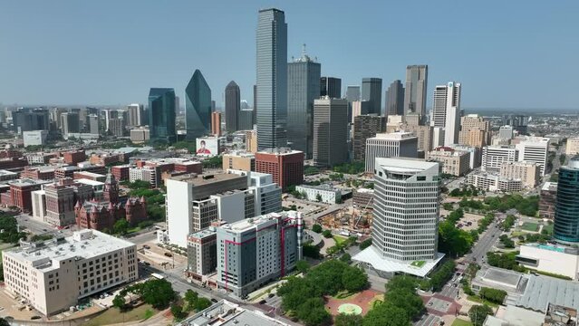 Aerial establishing shot of downtown Dallas Texas on sunny day. Highrise building skyscrapers on skyline.